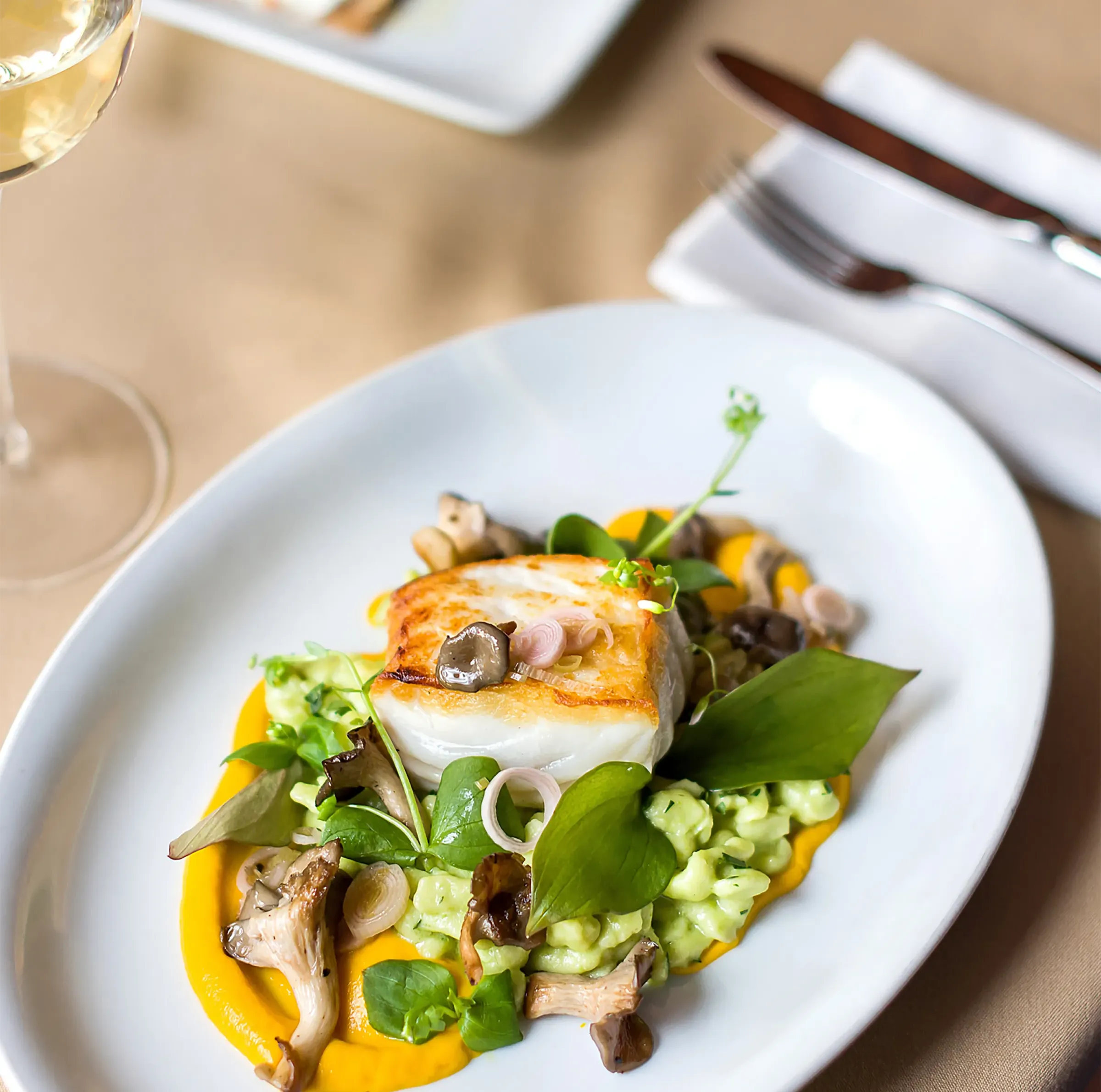 Fresh fish on top of risotto with vegetables expertly crafted by a dedicated chef at The Reserve.