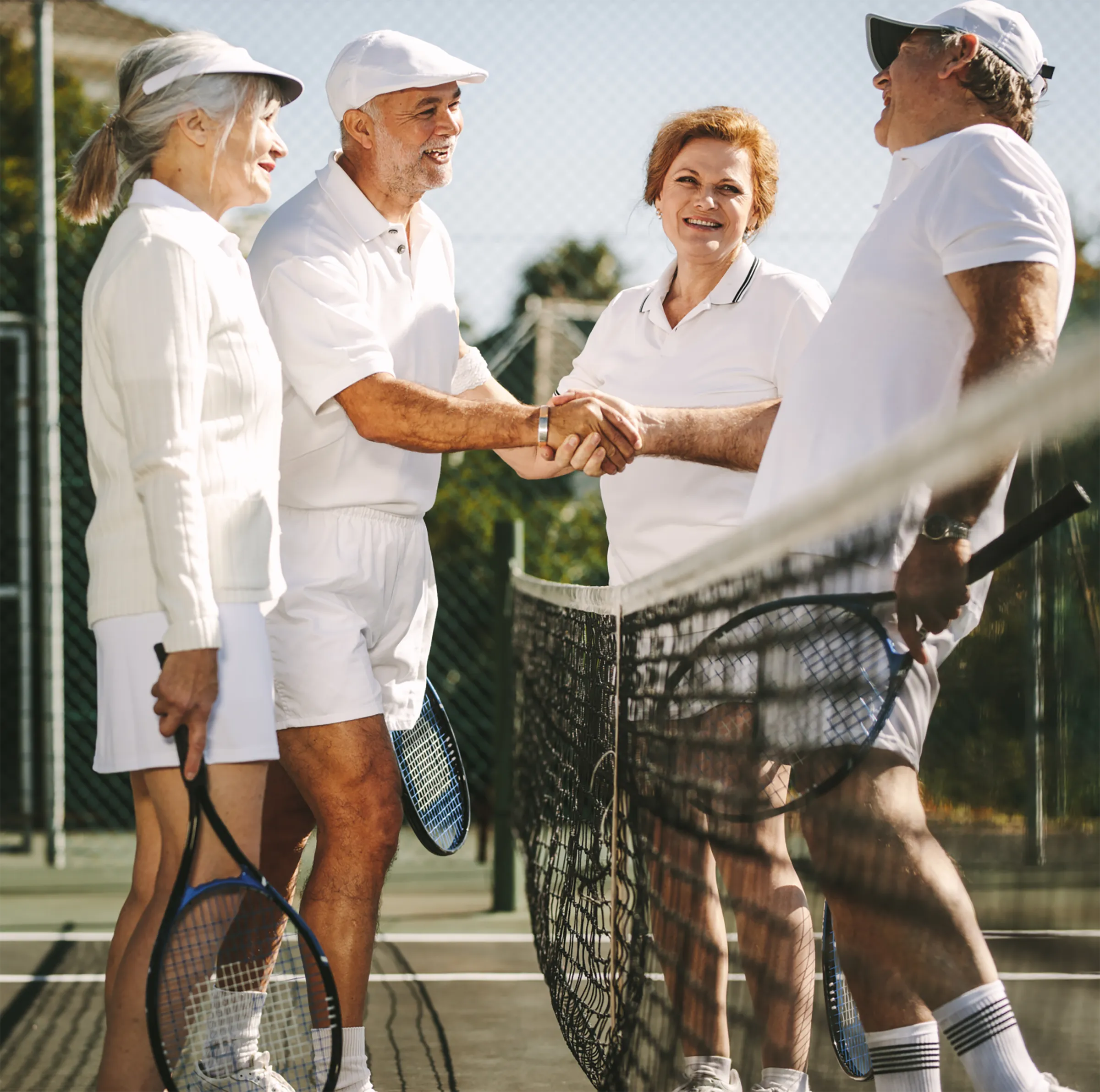 A group of residents on a tennis court shaking hands across the net
